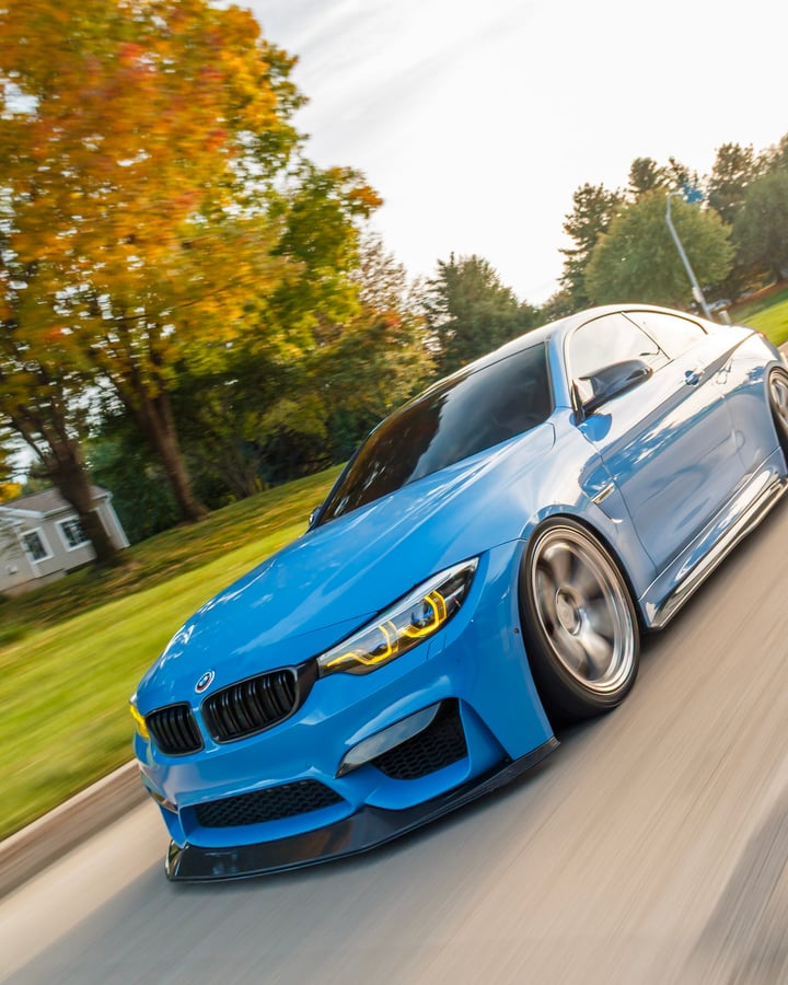 Blue BMW rolling shot by Kenny, front three-quarter in motion