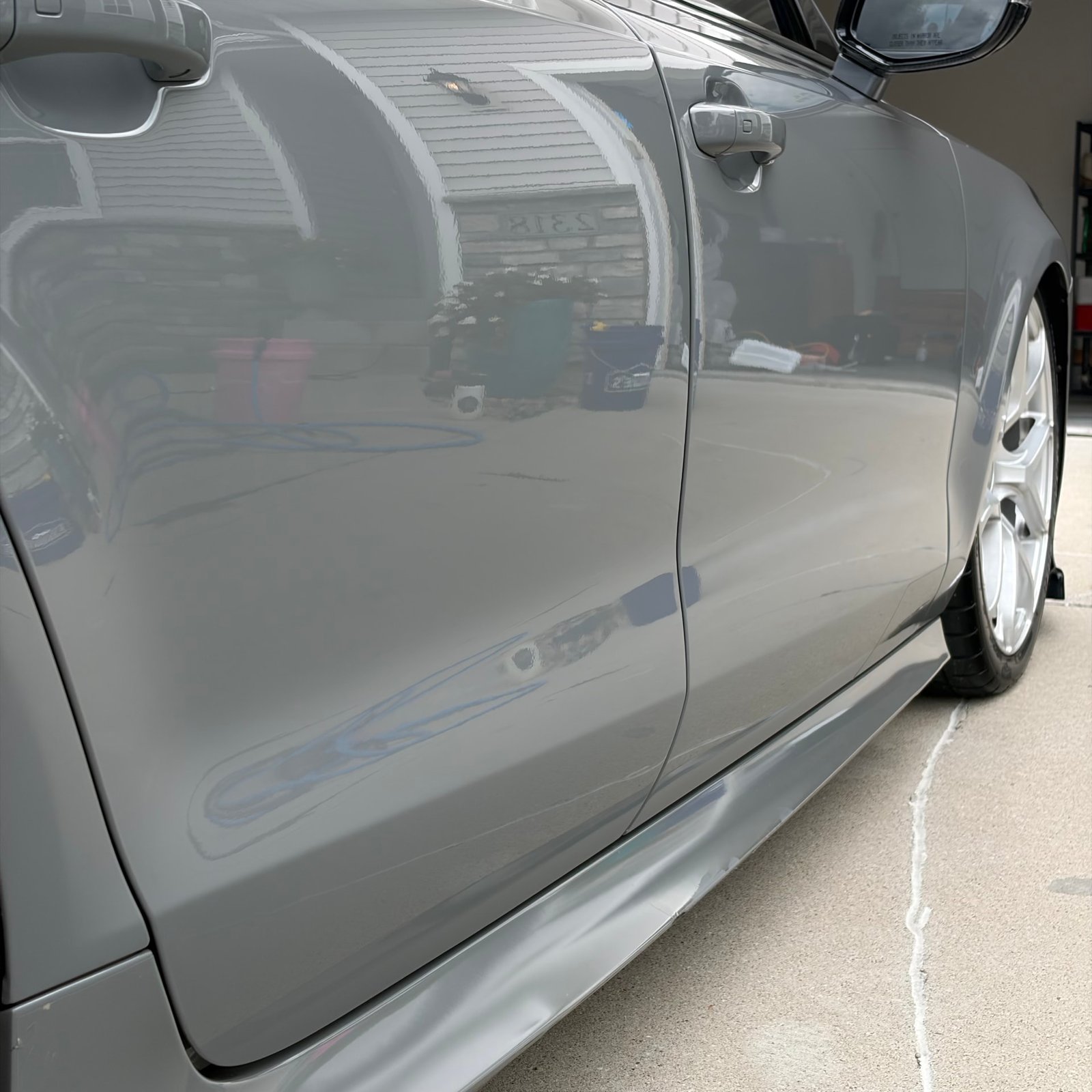 Sharp reflections in the corrected paint of a Nardo Grey Audi RS7