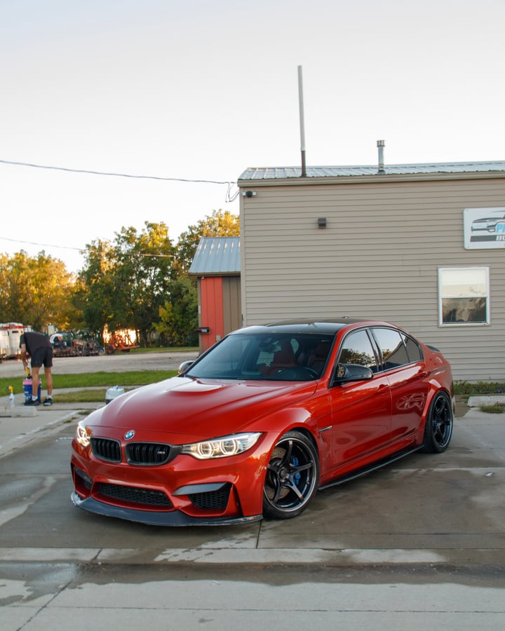 Orange BMW M3 front three-quarter photographed by Kenny