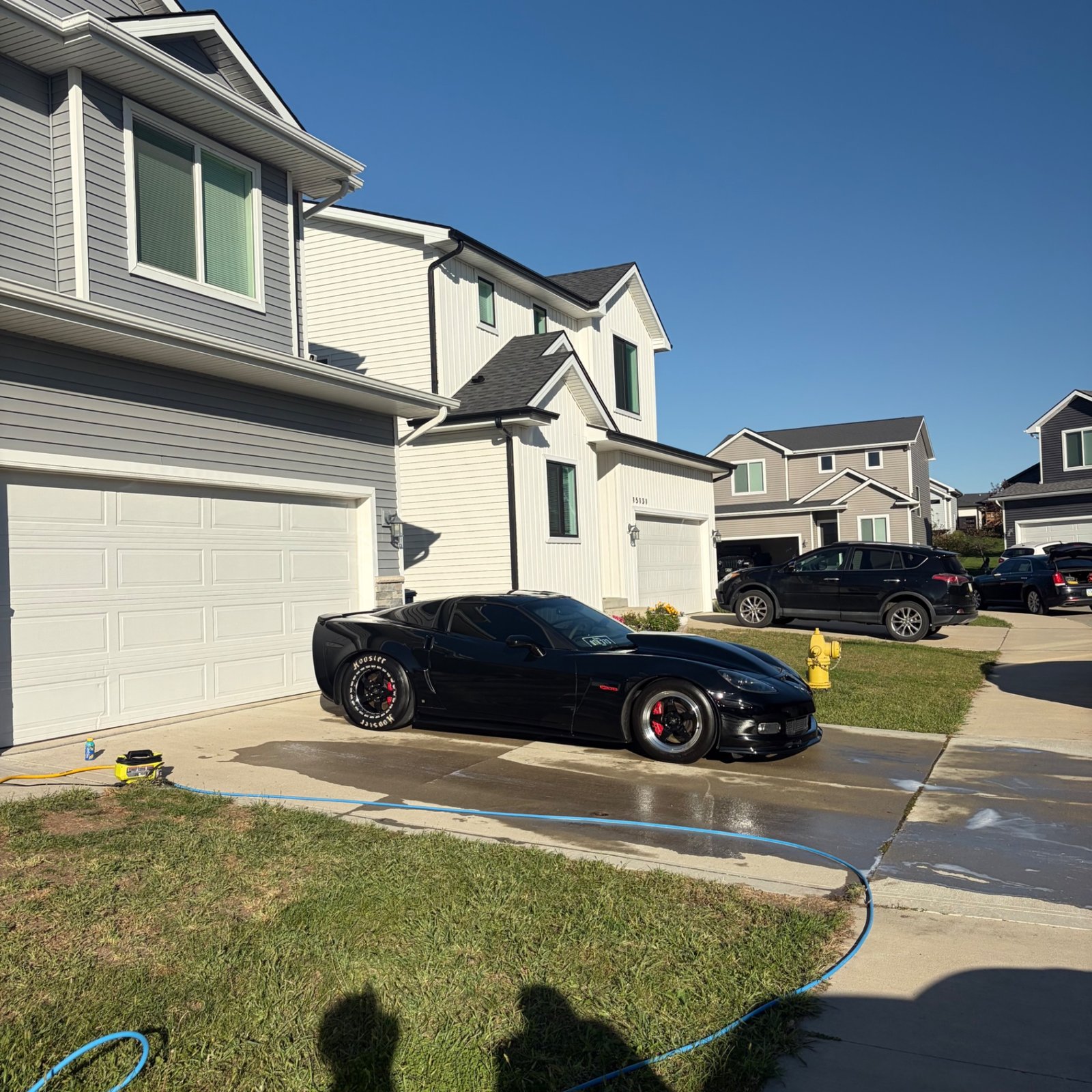 Black Corvette C6 Z06 on Hoosier drag wheels in the driveway after an exterior detail in Urbandale