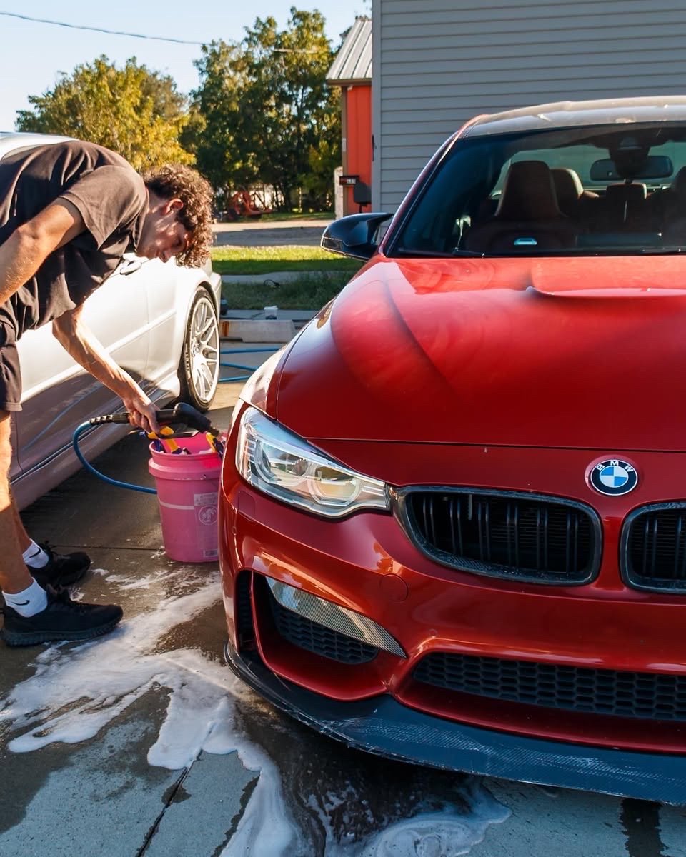 Jake washing the red BMW F80 M3 during the Waukee maintenance visit