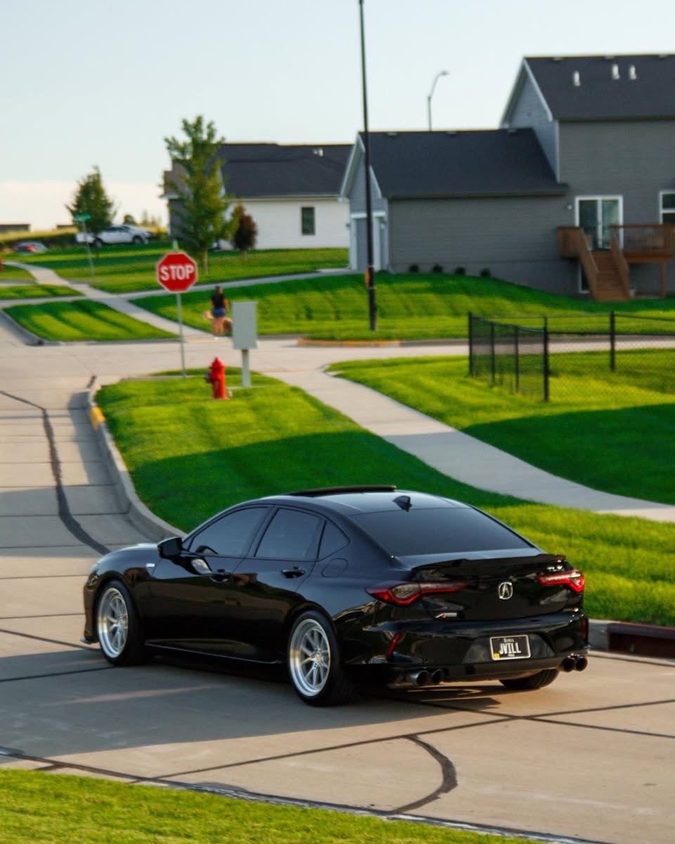Rear quarter of the black Acura TLX after exterior detailing
