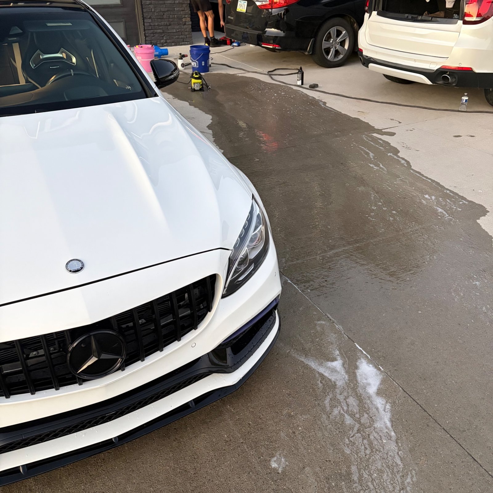 White Mercedes-AMG C 63 S hood and grille washed during the Waukee exterior detail