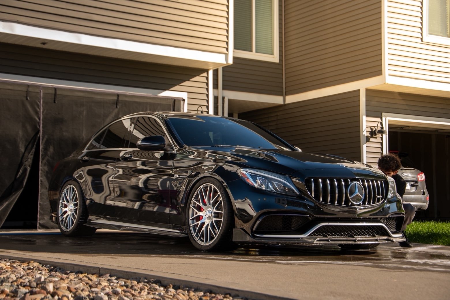 Side profile of the black AMG C 63 S after its Waukee exterior detail