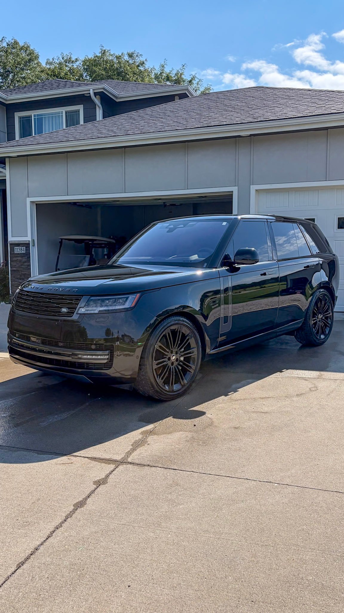 Black Range Rover in front of the garage after a full detail in West Des Moines