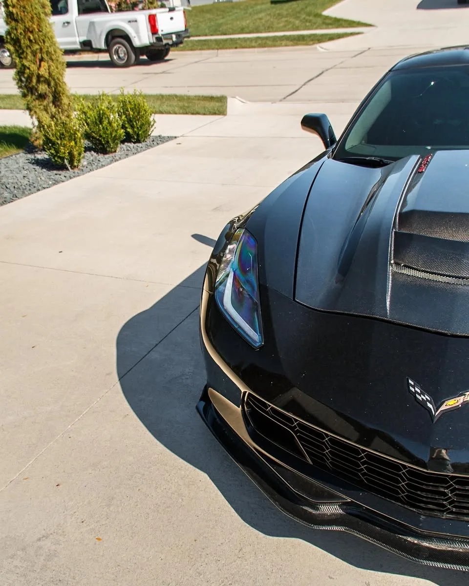 Black 1,084 HP Corvette C7 Z06 headlight and carbon hood after the wash