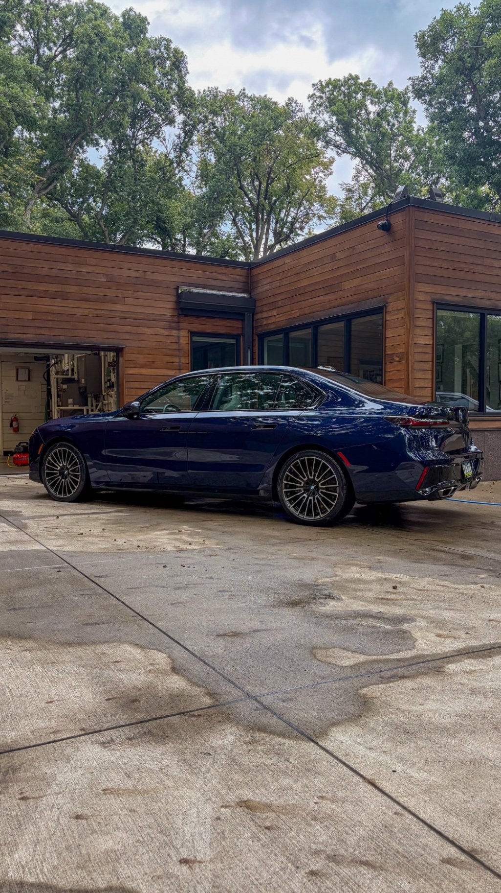 Side and rear profile of a detailed BMW M760i xDrive