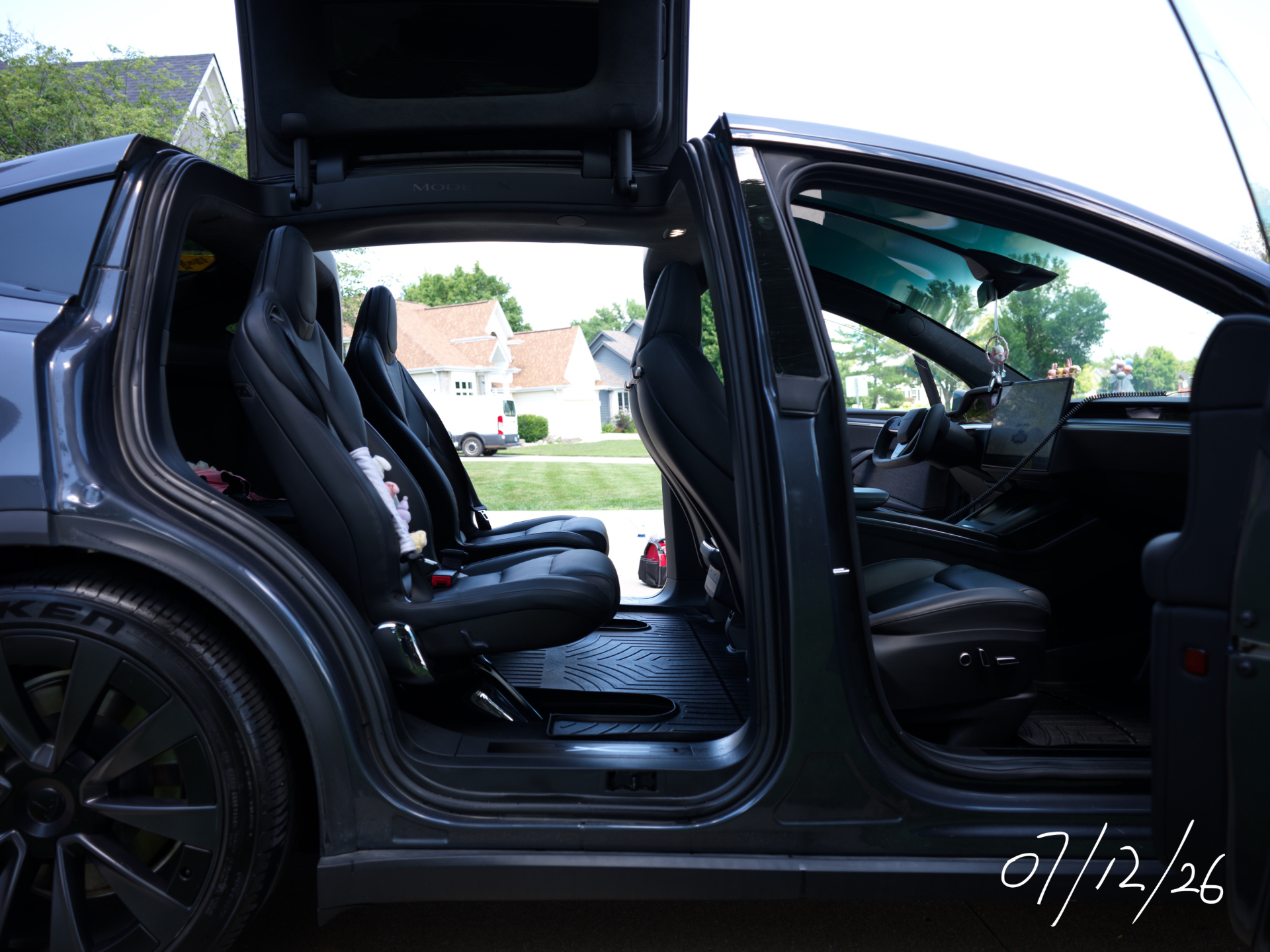 Falcon-wing doors open on a detailed Tesla Model X Plaid