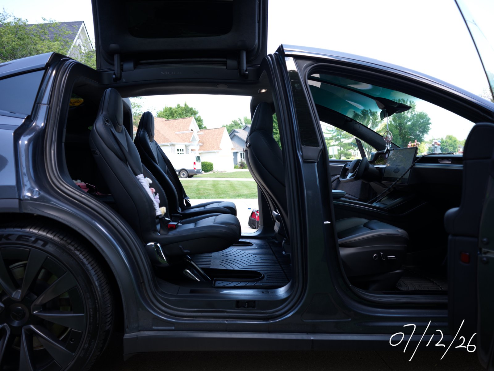 Falcon-wing doors open on a detailed Tesla Model X Plaid