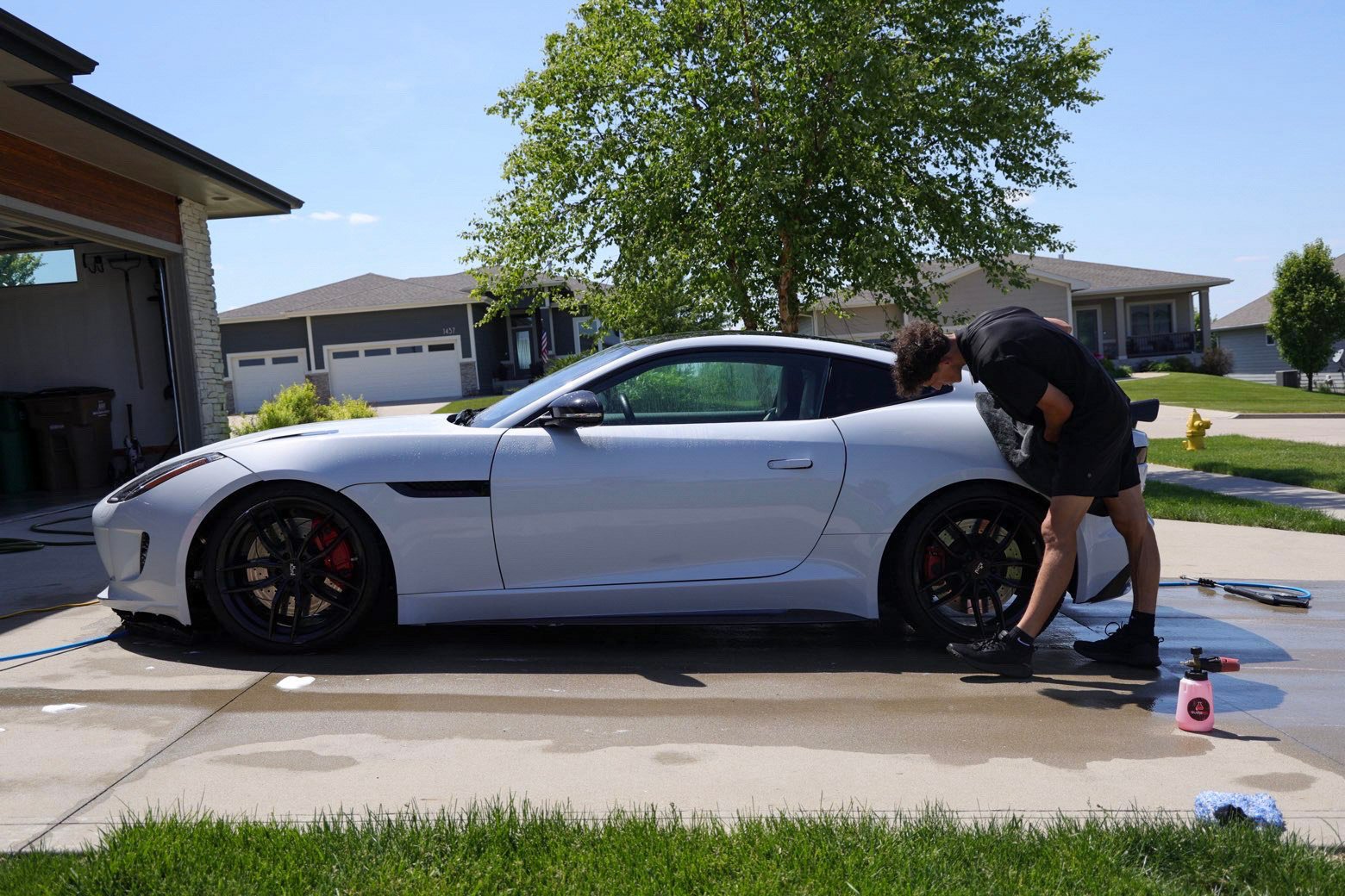 White Jaguar F-Type side profile during a full detail in West Des Moines