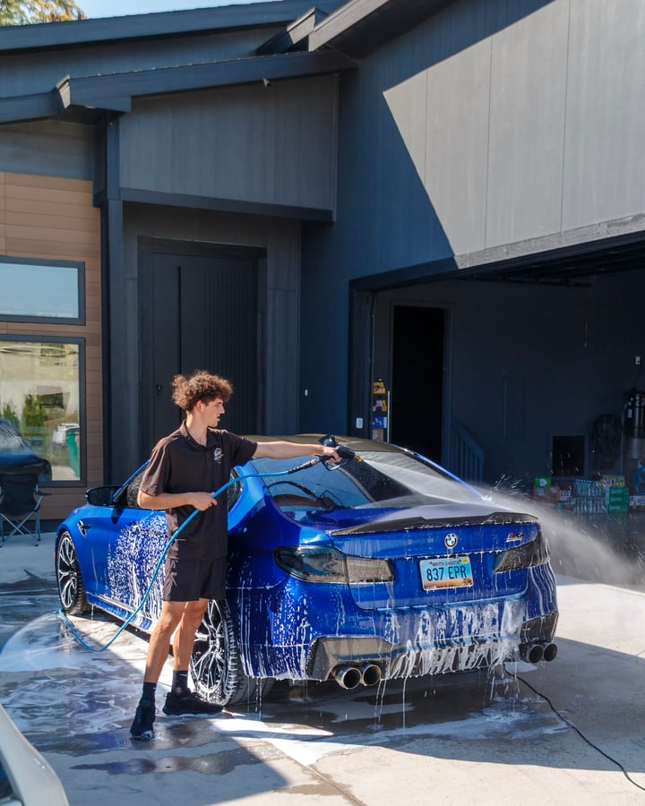 Jake foam washing a blue BMW, photographed by Kenny