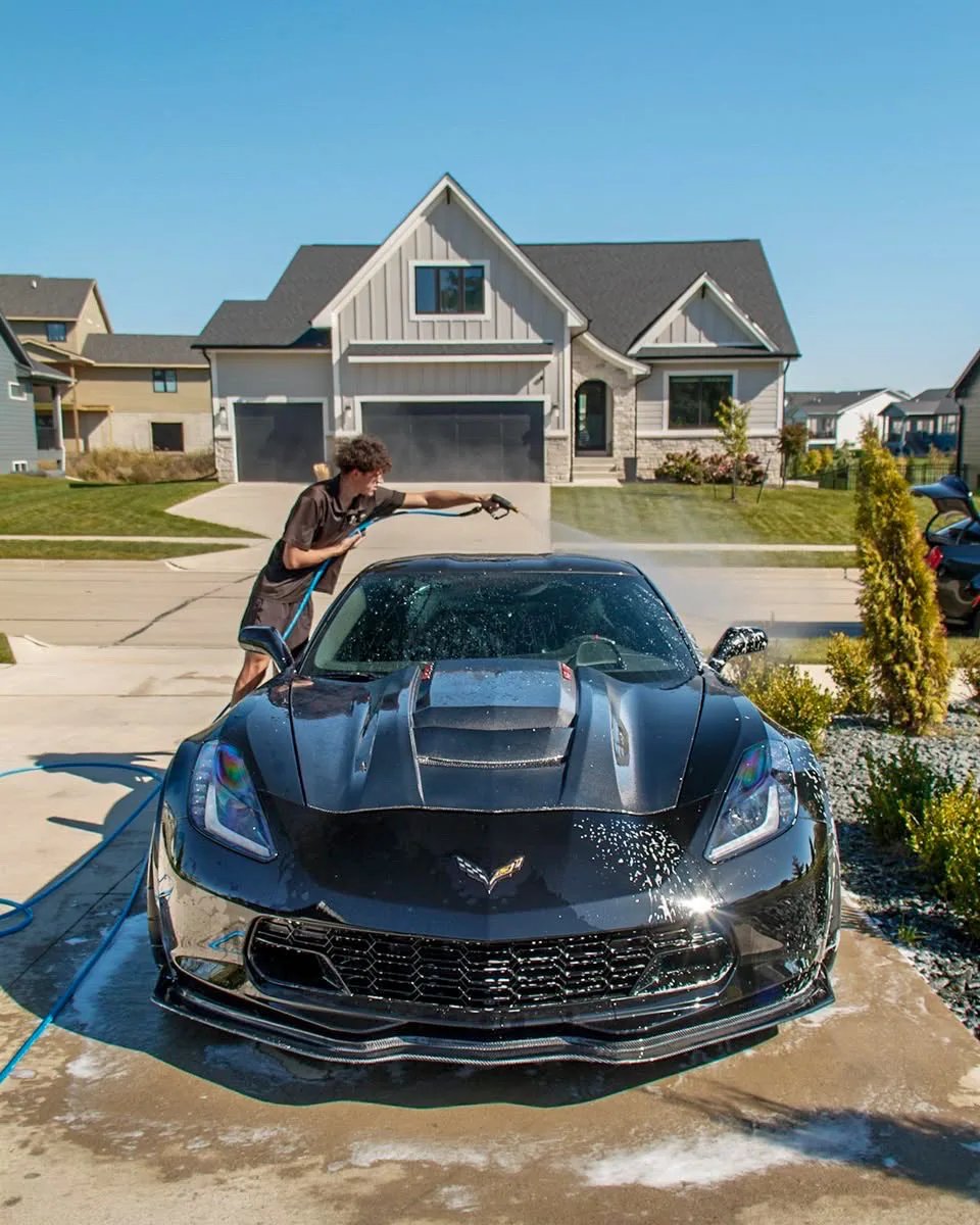 Black 1,084 HP Corvette C7 Z06 Jake rinsing the Corvette in a Clive driveway