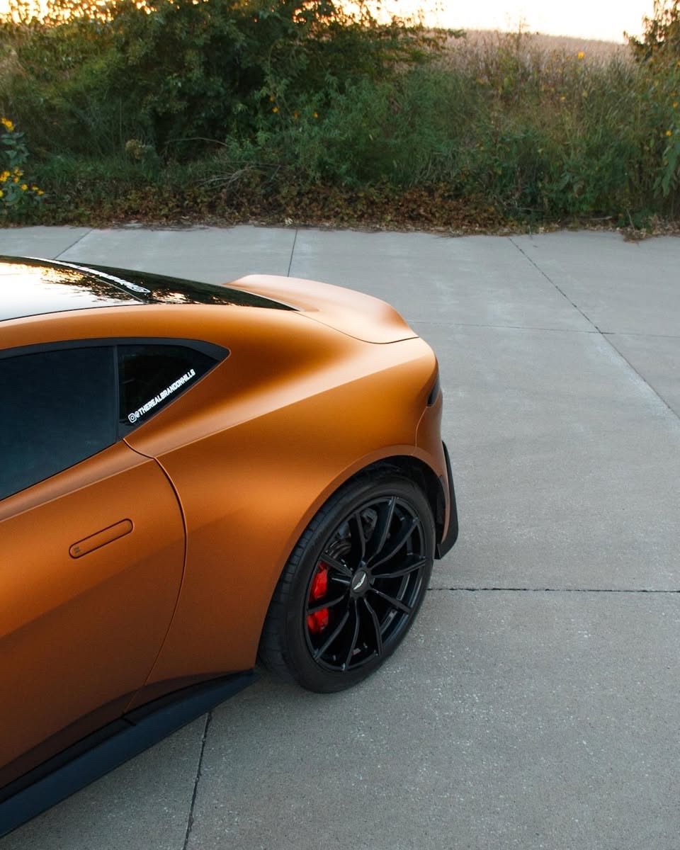 Matte orange Aston Martin Vantage rear fender and wheel after an exterior detail in Altoona
