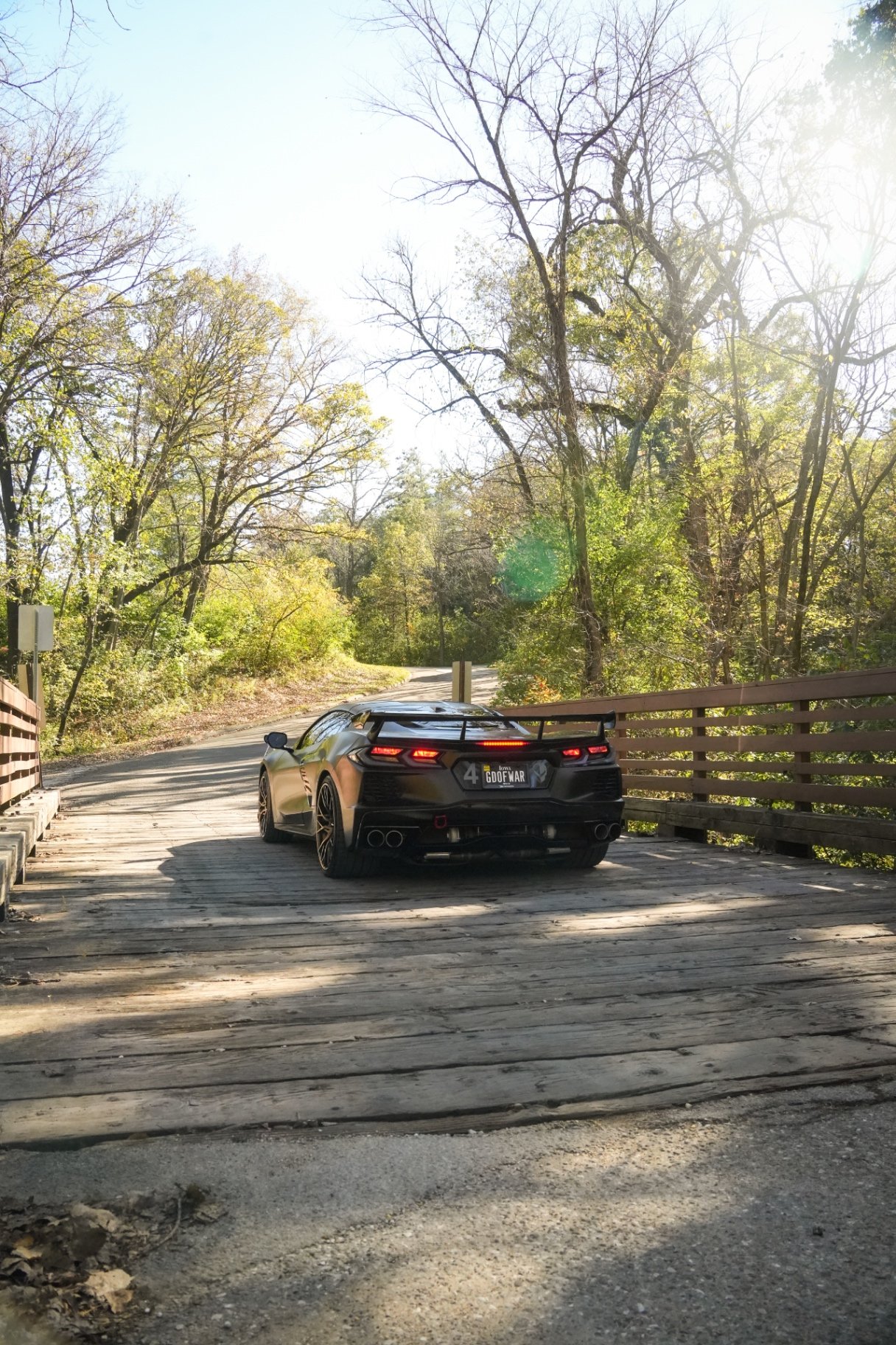 Black twin turbo Corvette C8 on a wooden bridge, rear quarter after a Premium Full Detail in Johnston