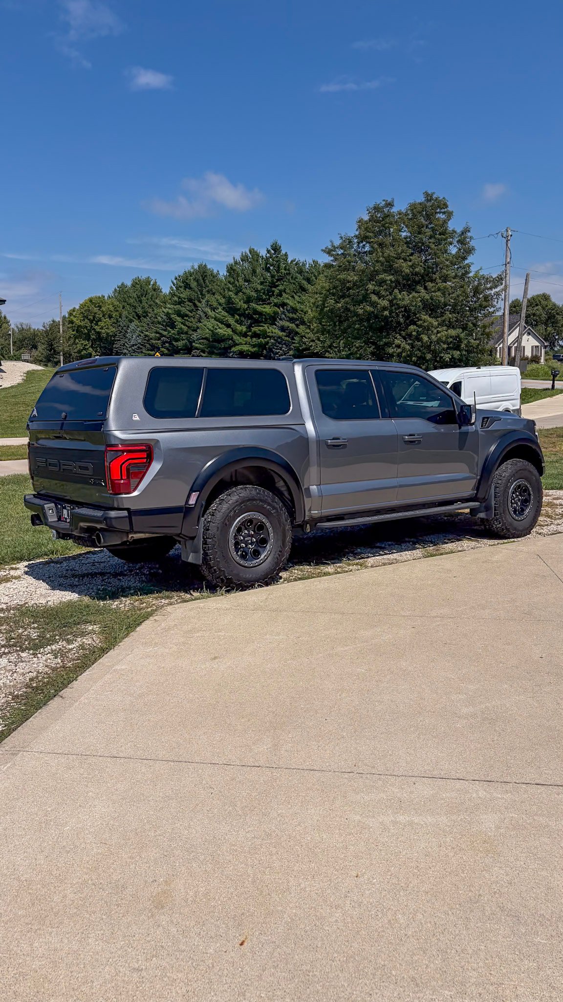 Gray Ford Raptor in the driveway after a full detail in West Des Moines