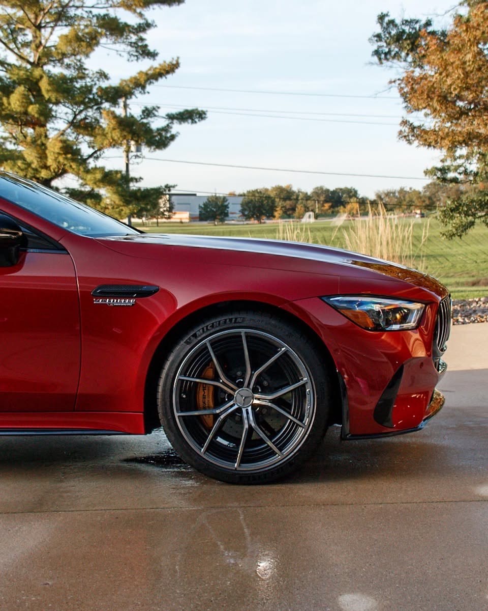 Clean front wheel, gold brake caliper and red bodywork of the Mercedes-AMG GT 63 S
