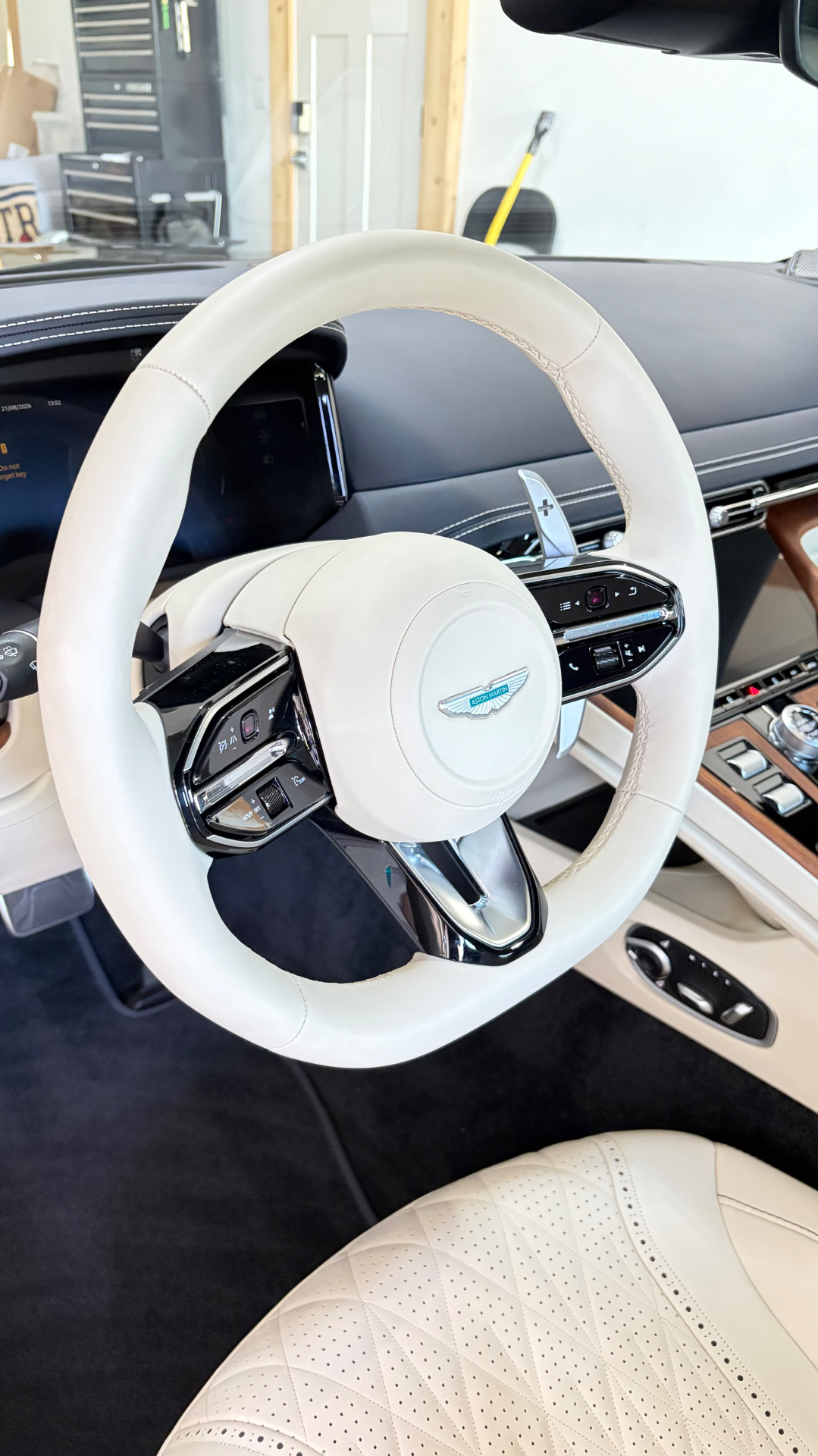 Steering wheel and cockpit detail on an Aston Martin DB12 Volante