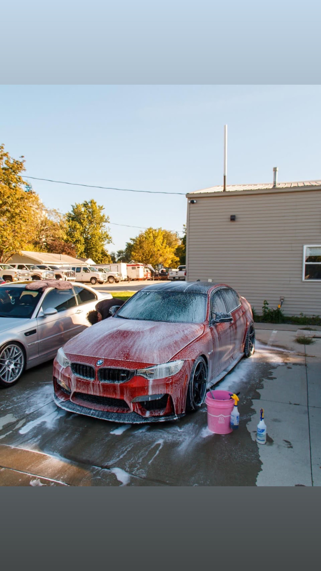 Red BMW F80 M3 covered in foam during its maintenance wash in Waukee