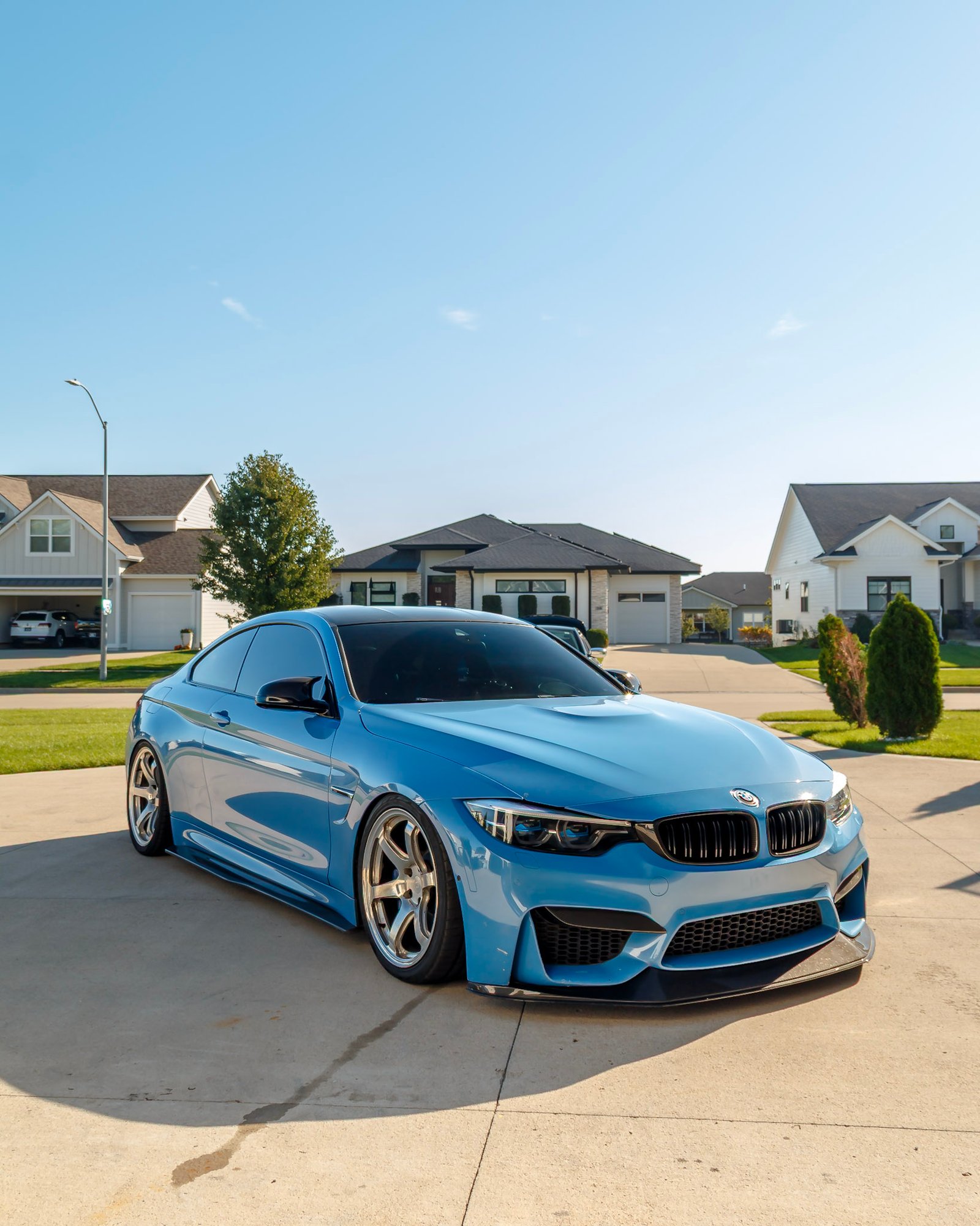 Light blue BMW M4 front three-quarter on the driveway after a Full Detail in West Des Moines