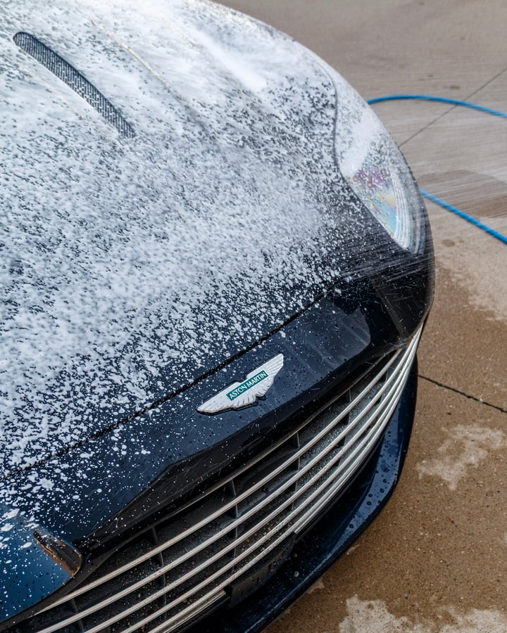Aston Martin grille covered in foam during a wash, photographed by Kenny