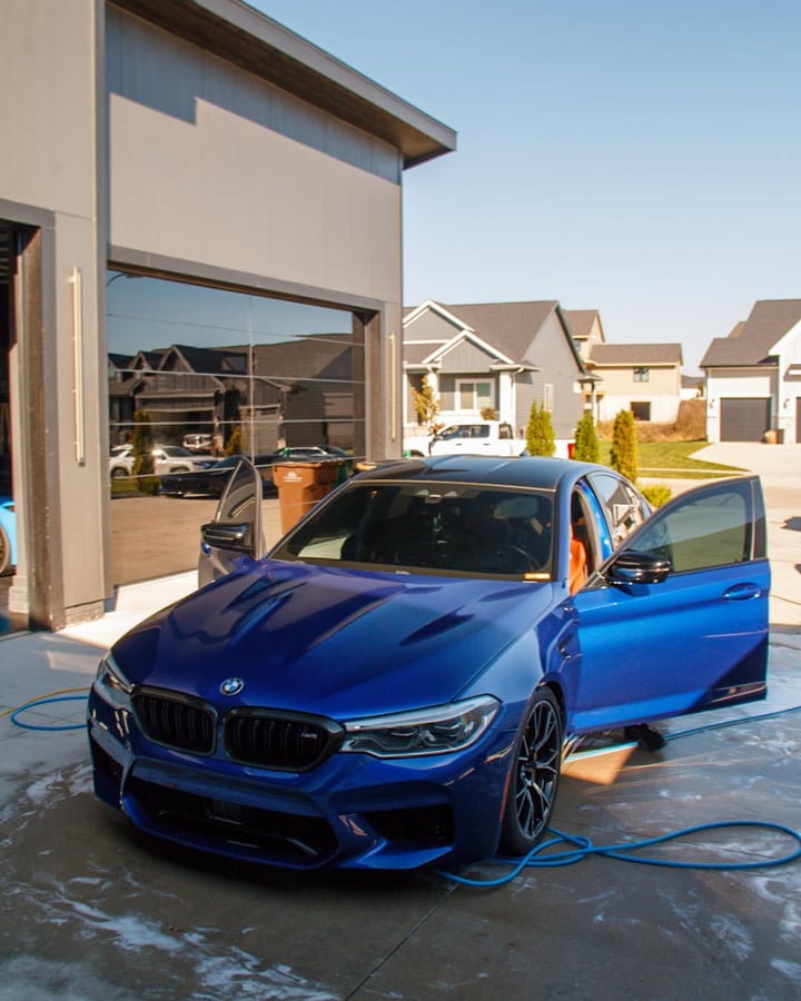 Blue 800 HP BMW M5 Competition during an exterior detail in Clive