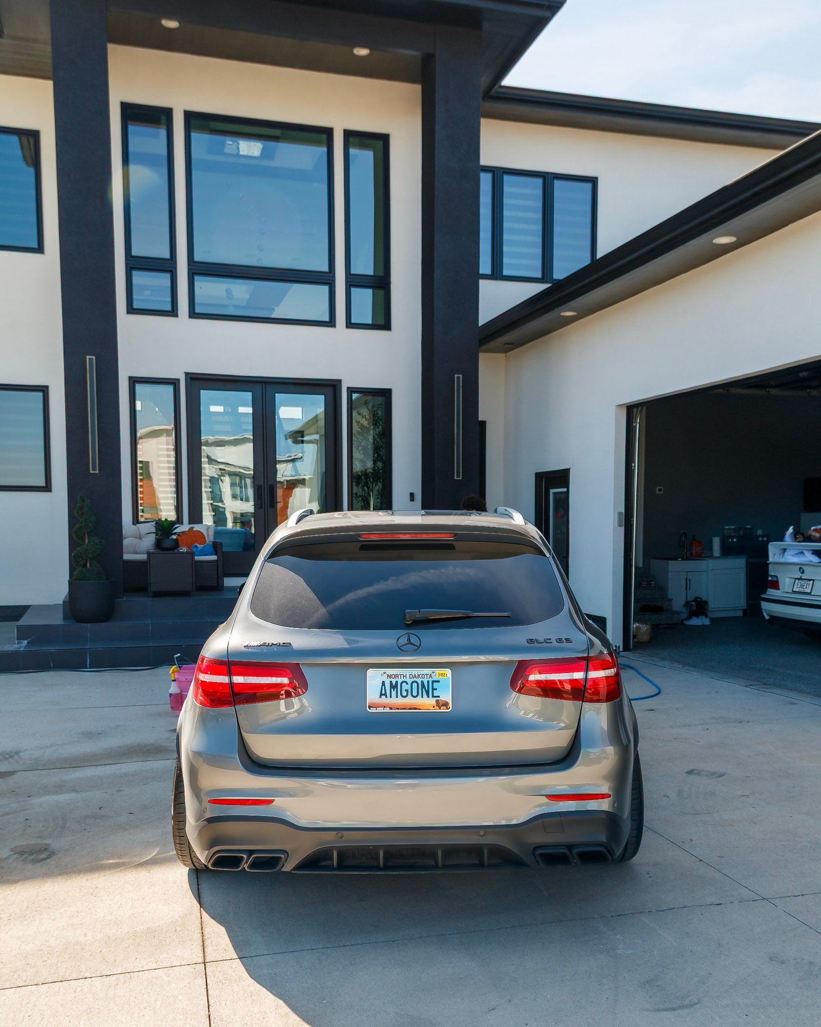 Rear of the grey Mercedes-AMG GLC 63 in the driveway