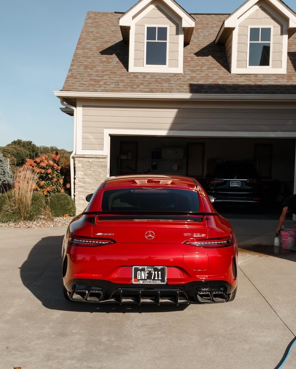 Finished red Mercedes-AMG GT 63 S rear view in front of the garage