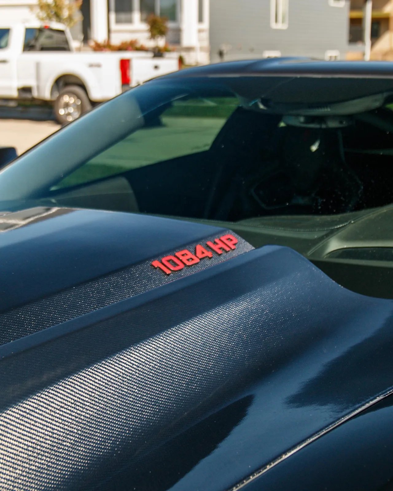 Black 1,084 HP Corvette C7 Z06 carbon hood with 1084 HP badge after detailing