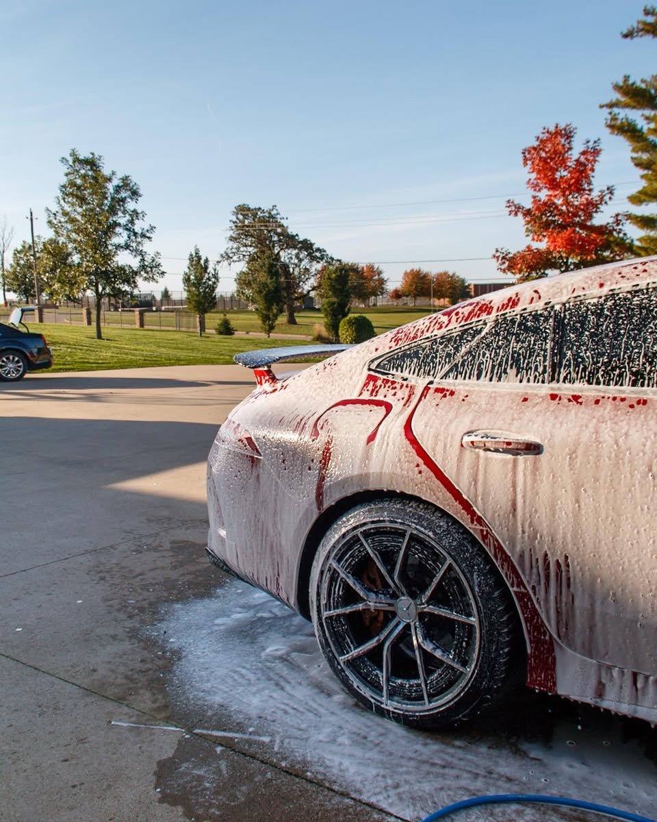 Foam covering the Mercedes-AMG GT 63 S rear quarter and wheel during the wash