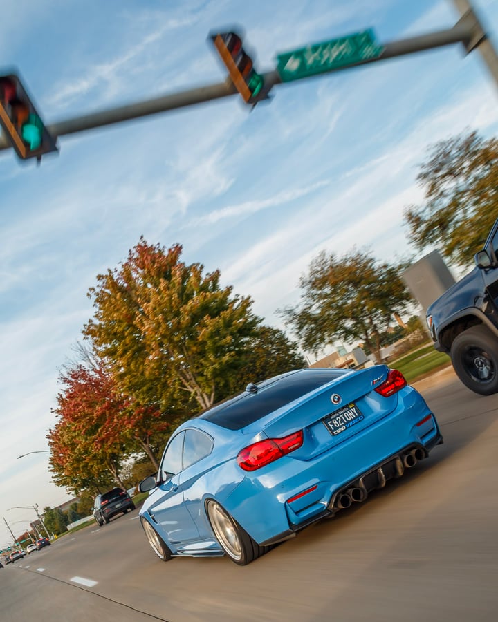 Blue BMW rolling shot by Kenny at an intersection
