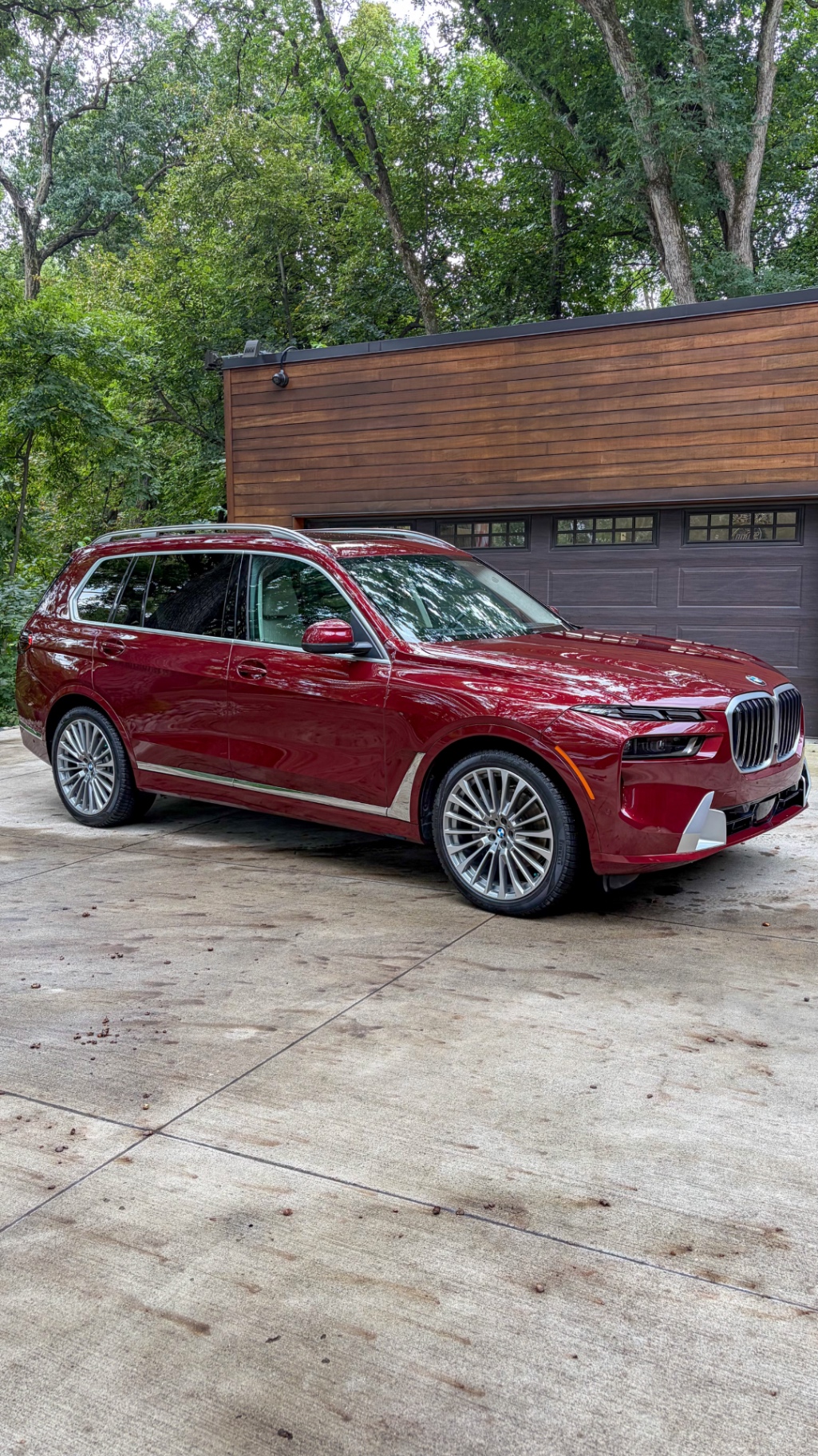 Front quarter of a BMW X7 detailed in the owner's driveway