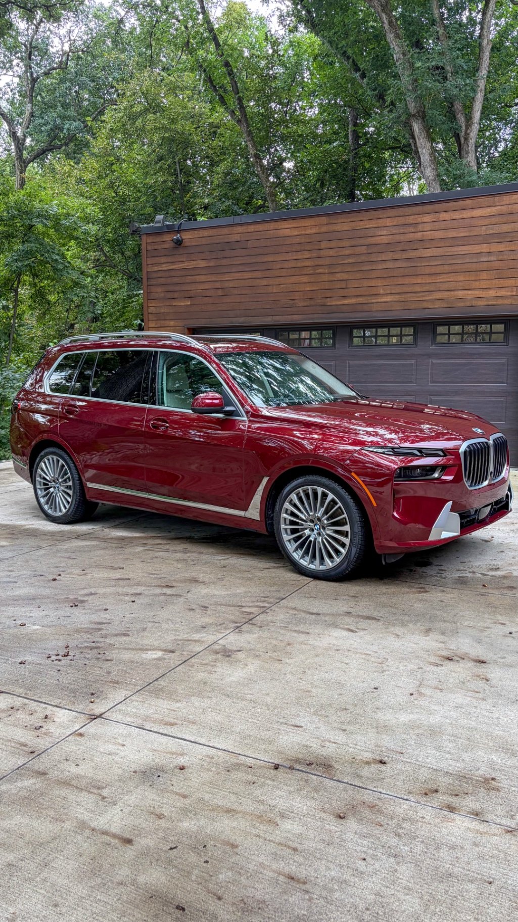 Front quarter of a BMW X7 detailed in the owner's driveway