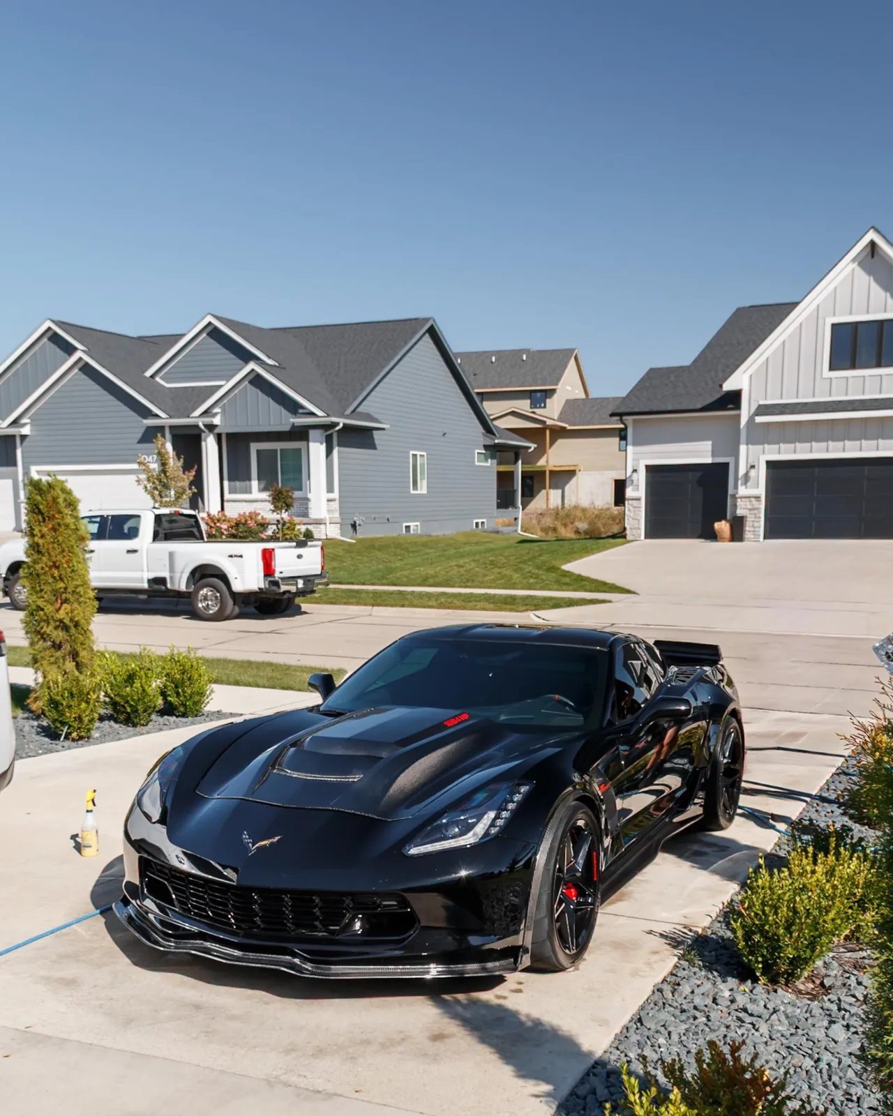 Black 1,084 HP Corvette C7 Z06 front quarter in the driveway after an exterior detail in Clive