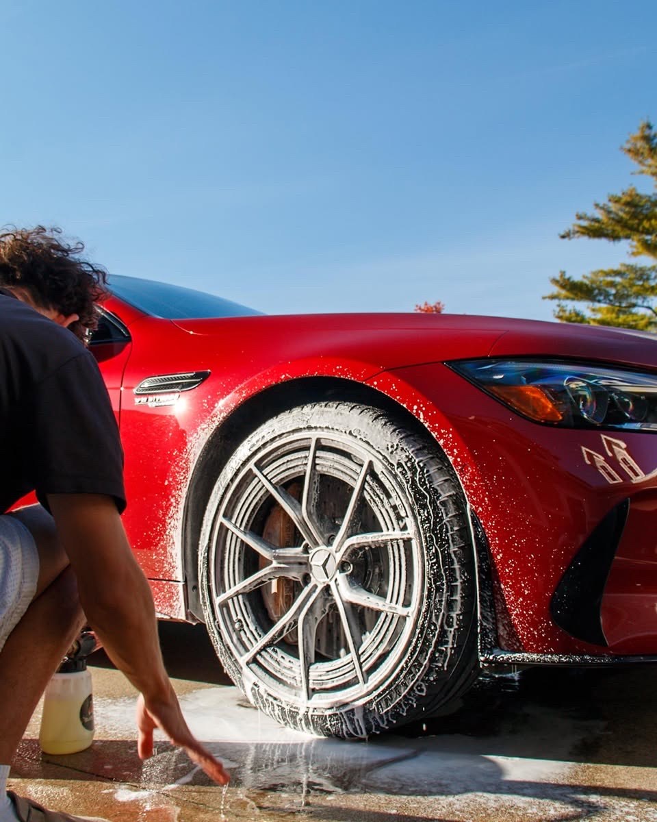 Jake cleaning the Mercedes-AMG GT 63 S front wheel with foam